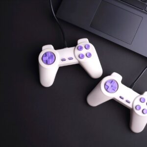 Two joystick game controllers with laptop