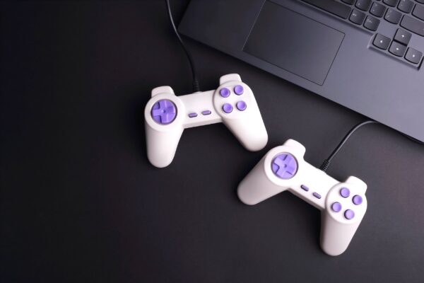 Two joystick game controllers with laptop