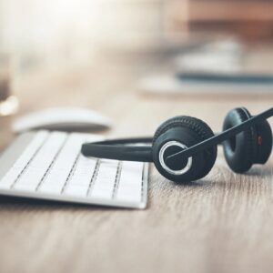 Shot of a pair of headsets lying on the desk in an empty office