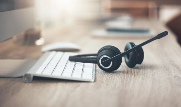 Shot of a pair of headsets lying on the desk in an empty office